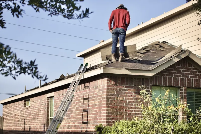 Professional roofer working on a residential roof in Penns Neck